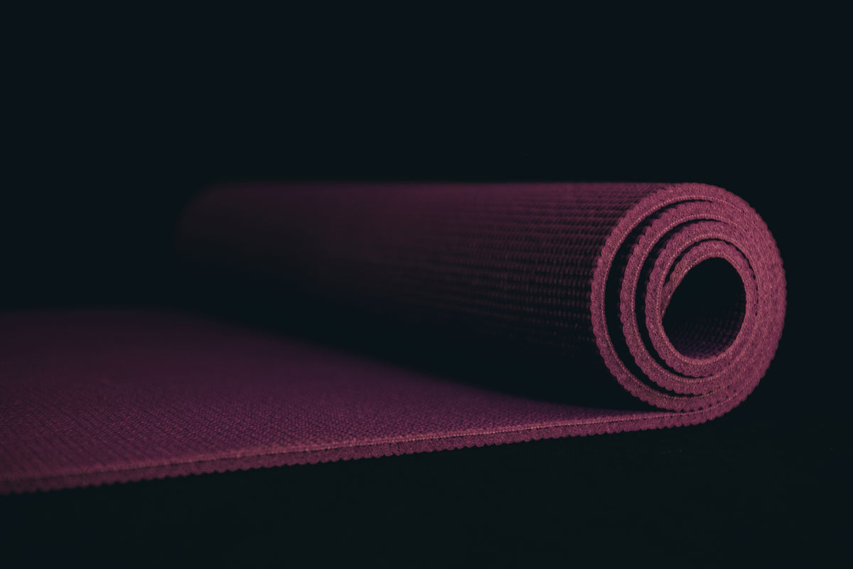 purple-yoga-mat-on-a-black-floor.jpg